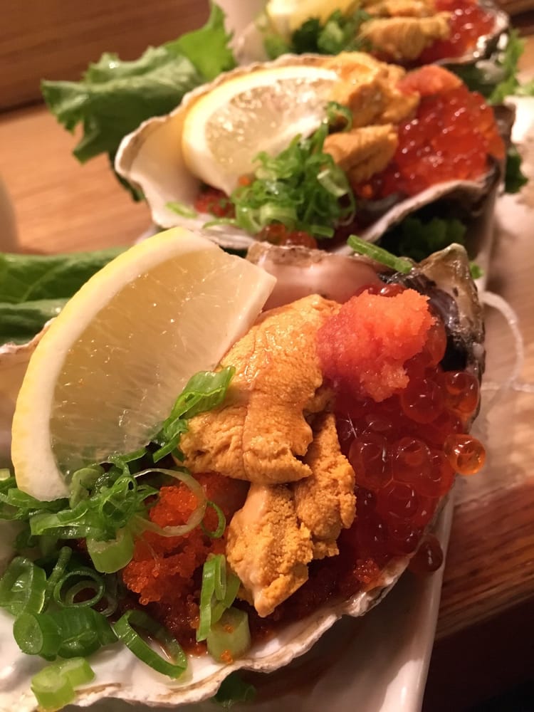 Oysters topped with sea urchin, salmon roe and green onion