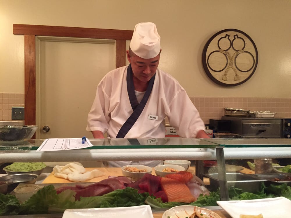 Sushi chef working behind the sushi bar