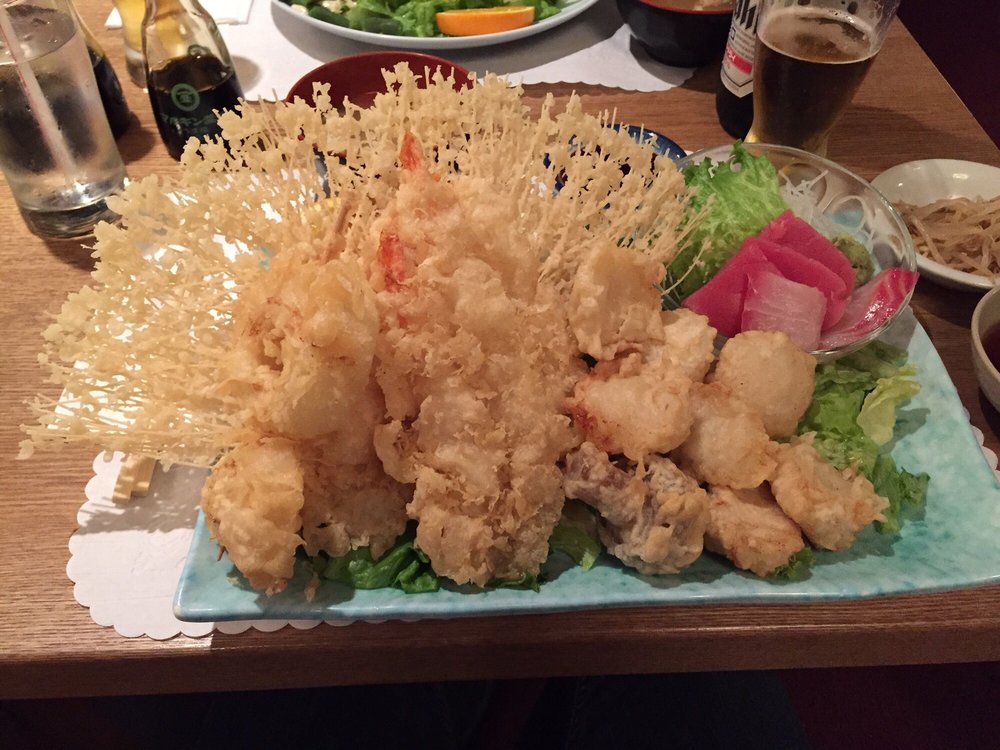 Tempura with a lacy fried crust beside a plate of sashimi