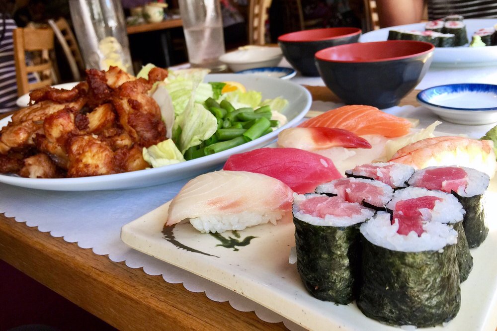 Chicken teriyaki with salad, nigiri and rolls